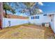 Unlandscaped backyard with a white fence and AC unit at 27466 Us Highway 19 N # 78, Clearwater, FL 33761