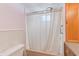 Bright bathroom with a tub shower and shower curtain at 27466 Us Highway 19 N # 78, Clearwater, FL 33761