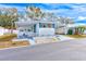 Front view of a white mobile home with carport, showing landscaping at 27466 Us Highway 19 N # 78, Clearwater, FL 33761