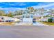 White single-wide mobile home with carport and landscaped yard at 27466 Us Highway 19 N # 78, Clearwater, FL 33761