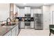 Modern kitchen featuring stainless steel appliances and granite countertops at 2943 Rambler Ivy Loop, Brandon, FL 33510