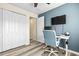 Bedroom featuring an adjustable desk, chair, and closet with sliding doors at 31211 Gossamer Way, Wesley Chapel, FL 33543