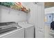 Convenient laundry room with a washer, dryer, and storage shelf at 31211 Gossamer Way, Wesley Chapel, FL 33543