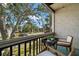 Screened balcony with outdoor furniture and a leafy view at 3245 Beneva Rd # 201, Sarasota, FL 34232