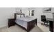 Bedroom with dark wood frame bed and workspace at 3245 Beneva Rd # 201, Sarasota, FL 34232