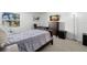 Comfortable bedroom with a dresser, desk, and a view from the window at 3245 Beneva Rd # 201, Sarasota, FL 34232