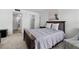 Spacious bedroom with dark wood bed and access to bathroom at 3245 Beneva Rd # 201, Sarasota, FL 34232