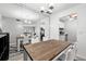 Dining room with wood table, white chairs, and kitchen view at 3245 Beneva Rd # 201, Sarasota, FL 34232