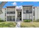 Two-story condo building with screened balconies and lush landscaping at 3245 Beneva Rd # 201, Sarasota, FL 34232