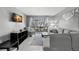 Bright living room with gray sectional sofa and access to balcony at 3245 Beneva Rd # 201, Sarasota, FL 34232