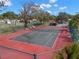 Well-maintained tennis court with seating areas at 3245 Beneva Rd # 201, Sarasota, FL 34232