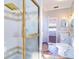 Bathroom featuring glass shower, tile floor, and a view into the adjacent bedroom at 335 Palmdale Dr, Oldsmar, FL 34677