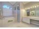 Spacious bathroom featuring a soaking tub, shower, and vanity area with double mirrors at 335 Palmdale Dr, Oldsmar, FL 34677