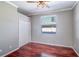 Bright bedroom featuring wood floors, a ceiling fan, and a window for natural light at 335 Palmdale Dr, Oldsmar, FL 34677