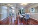 Elegant dining room with hardwood floors, large windows, and a glass dining table at 335 Palmdale Dr, Oldsmar, FL 34677