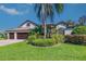 Charming two-story home with lush landscaping and a well-manicured lawn at 335 Palmdale Dr, Oldsmar, FL 34677