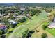 An aerial view of a lush golf course surrounded by mature trees and beautiful residences at 335 Palmdale Dr, Oldsmar, FL 34677