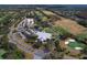 Aerial shot of a golf course with manicured greens, a clubhouse, and surrounding lush landscaping at 335 Palmdale Dr, Oldsmar, FL 34677