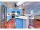 Bright kitchen with stylish blue cabinets, stainless steel appliances, and a marble countertop at 335 Palmdale Dr, Oldsmar, FL 34677