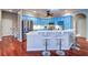 Updated kitchen with stainless steel appliances, blue cabinetry, and an eat-in breakfast bar at 335 Palmdale Dr, Oldsmar, FL 34677