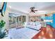 Bright living room with pool views, hardwood floors, and an open floor plan connected to the kitchen at 335 Palmdale Dr, Oldsmar, FL 34677