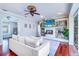 Cozy living room featuring a fireplace, built-in shelves, and an open layout with hardwood floors at 335 Palmdale Dr, Oldsmar, FL 34677