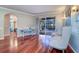 Open living area with hardwood floors, stylish seating, and views of the screened in pool at 335 Palmdale Dr, Oldsmar, FL 34677