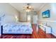 Bright main bedroom with wood floors, a ceiling fan, and a mounted television at 335 Palmdale Dr, Oldsmar, FL 34677