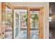 Private balcony with a view of palm trees and lush greenery at 3629 Gulf Blvd, St Pete Beach, FL 33706
