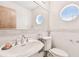 Clean bathroom with updated fixtures and a round window at 3629 Gulf Blvd, St Pete Beach, FL 33706