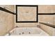 Relaxing bathroom with a jetted tub and granite accents at 3629 Gulf Blvd, St Pete Beach, FL 33706