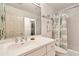 Clean bathroom with a vanity, toilet, shower, and stacked washer/dryer at 3629 Gulf Blvd, St Pete Beach, FL 33706