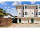 Two-story townhome building with garages and green doors at 3629 Gulf Blvd, St Pete Beach, FL 33706