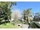 Partial view of backyard showing lush landscaping and a bird feeder at 4409 Ann Arbor Dr, Tampa, FL 33610