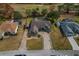 Aerial view of a house with pool and paved driveway, surrounded by lush landscaping at 5052 Florentine Ct, Spring Hill, FL 34608