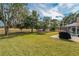 Large backyard with a trampoline and mature trees at 5052 Florentine Ct, Spring Hill, FL 34608