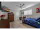 Spacious bedroom with dresser and ceiling fan at 5052 Florentine Ct, Spring Hill, FL 34608