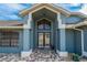 Front entrance with double doors and a decorative light fixture at 5052 Florentine Ct, Spring Hill, FL 34608