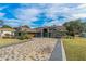 House exterior with a paver driveway and well-manicured lawn at 5052 Florentine Ct, Spring Hill, FL 34608