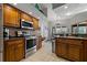 Modern kitchen featuring stainless steel appliances and wood cabinets at 5052 Florentine Ct, Spring Hill, FL 34608