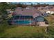 Large screened pool with brick patio and basketball hoop at 5052 Florentine Ct, Spring Hill, FL 34608