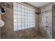 Modern walk-in shower with multiple shower heads at 5052 Florentine Ct, Spring Hill, FL 34608