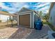 Detached storage shed with a brown garage door at 5052 Florentine Ct, Spring Hill, FL 34608