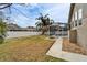 Fenced backyard with grassy lawn and fire pit at 5206 Whispering Leaf Trl, Valrico, FL 33596