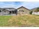 Large backyard with pool, screened enclosure, and fire pit at 5206 Whispering Leaf Trl, Valrico, FL 33596