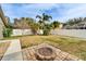 Spacious backyard with fire pit and grassy area at 5206 Whispering Leaf Trl, Valrico, FL 33596