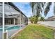 Landscaped backyard with pool, patio, and fire pit at 5206 Whispering Leaf Trl, Valrico, FL 33596