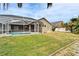 Spacious backyard oasis featuring a refreshing pool and screened enclosure at 5206 Whispering Leaf Trl, Valrico, FL 33596