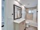 Clean bathroom with a bathtub, shower, and modern vanity at 5206 Whispering Leaf Trl, Valrico, FL 33596