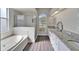Spa-like bathroom with double vanity, soaking tub, and walk-in shower at 5206 Whispering Leaf Trl, Valrico, FL 33596
